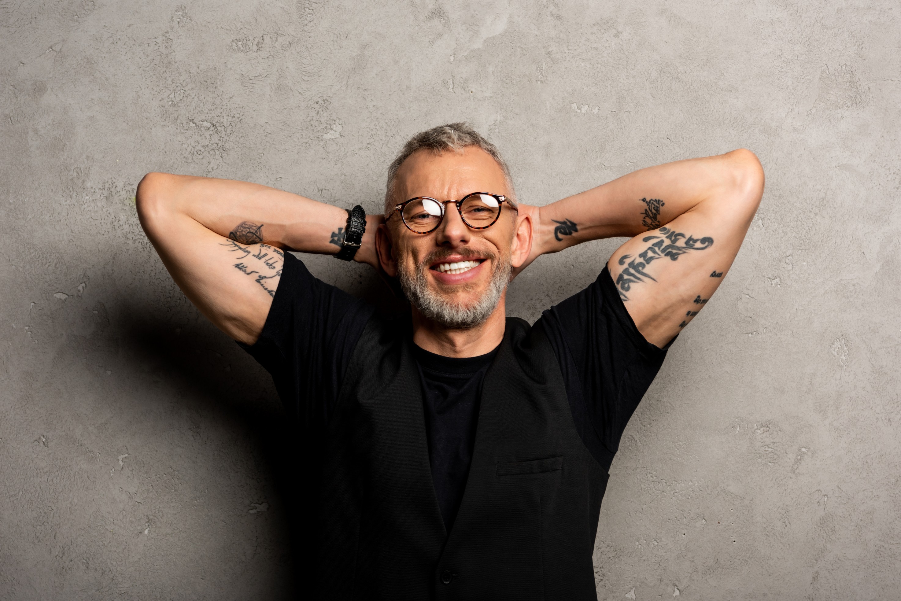 Man Smiles Wearing Glasses